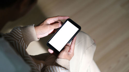 Midsection of woman using mobile phone