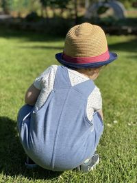 Rear view of man wearing hat on field