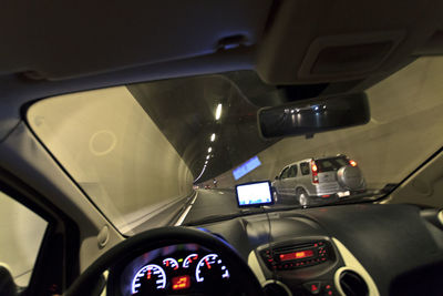 Cars moving on road seen through car windshield at night