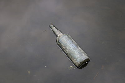 High angle view of bottle in river