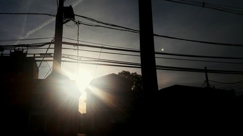 Low angle view of electricity pylon against sky