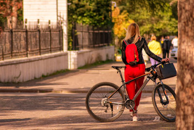 People riding bicycle on street in city