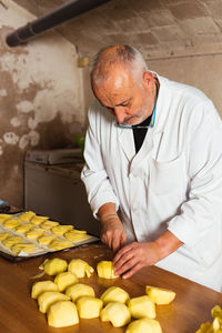 Midsection of chef preparing food in kitchen