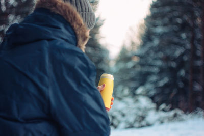 Midsection of woman holding umbrella during winter