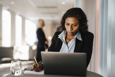 Woman using laptop in office