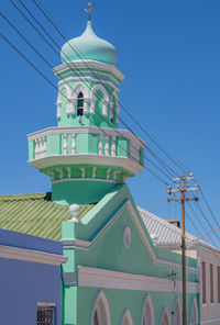 Low angle view of building against clear blue sky