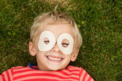 Portrait of smiling boy lying on grass