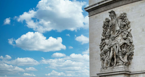 Low angle view of statue against historic building