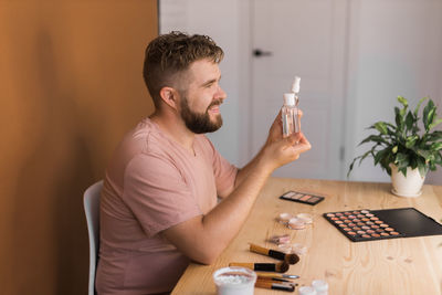 Side view of man using mobile phone