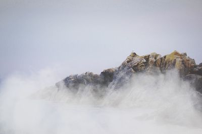 Scenic view of waterfall against sky