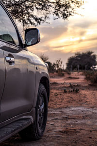 Close-up of car on road against sky