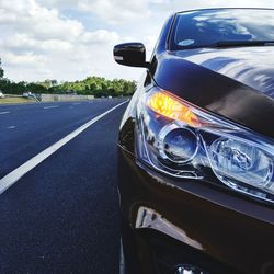 Close-up of car on road