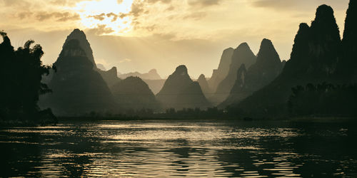 Panoramic view of river and mountains against sky