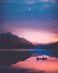 Silhouette people sitting in boat on lake against sky at night