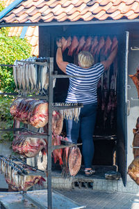 Rear view of woman standing at market stall