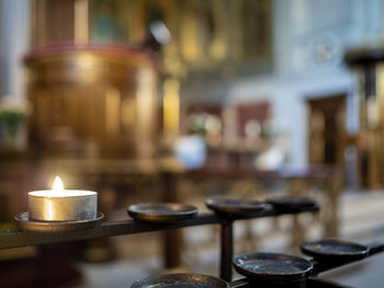 Close-up of illuminated tea light candles on table