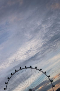 Low angle view of ferris wheel against sky