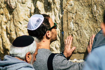 Group of people on rock against trees