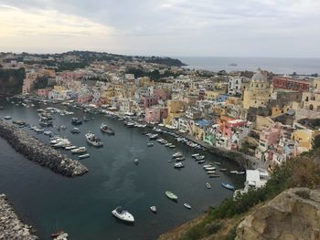 High angle view of townscape by sea against sky