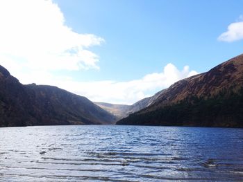 Scenic view of lake against cloudy sky