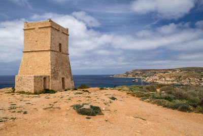 Historic building by sea against sky