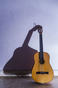 Guitar against wall at home