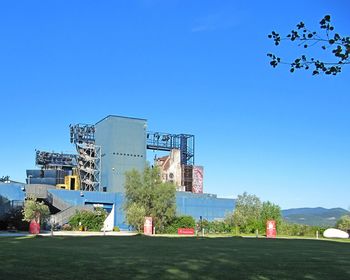 Low angle view of built structure against clear blue sky