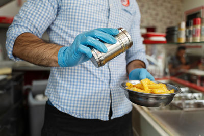 Midsection of man preparing food