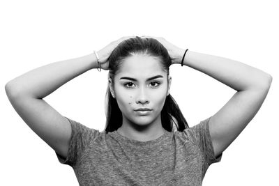 Portrait of young woman against white background