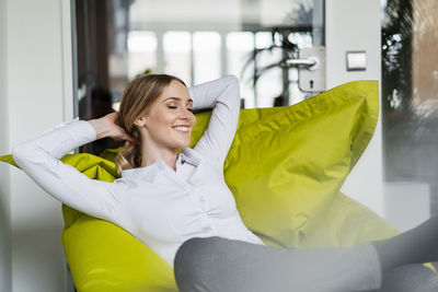 Young woman smiling while sitting on seat