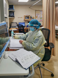 Midsection of woman working on table