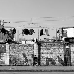 Low angle view of clothes drying below wall