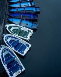 Small rowing boats tied up together on river avon