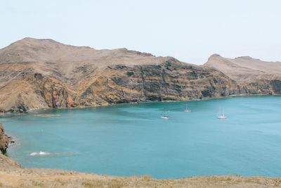 Scenic view of sea and mountains against sky