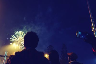 People enjoying concert at night