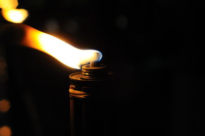 Close-up of oil lamp burning in darkroom