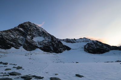 Scenic view of snow covered mountains against sky