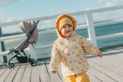 Rear view of woman standing on pier