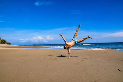 Low angle view of person on beach against sky