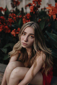 Portrait of young woman sitting outdoors