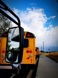 Train on railroad track against cloudy sky