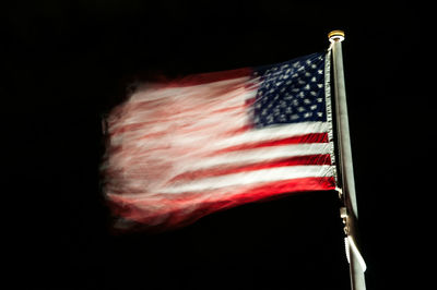 Low angle view of flag against black background