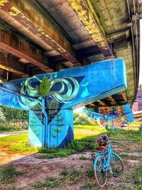 Graffiti on bicycle parked on field