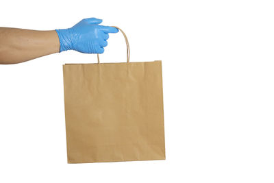 Person holding paper against white background