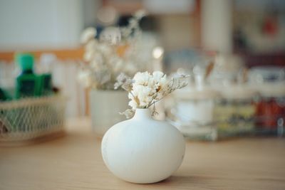 Close-up of flowers in vase on table at home