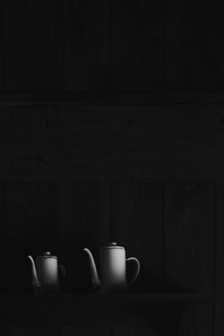 darkness, black, white, still life photography, light, indoors, black and white, monochrome, lighting, no people, food and drink, cup, wall, monochrome photography, still life, wood, mug, copy space, dark, tableware, drink, domestic room, shelf, jug, coffee cup, table
