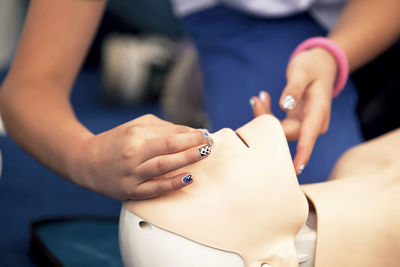 Paramedic performing cpr on mannequin