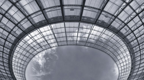 Low angle view of glass ceiling against sky