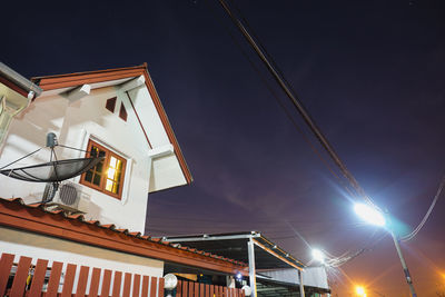 Low angle view of illuminated buildings against sky at night