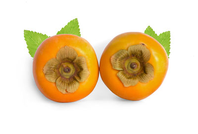 Close-up of orange slices over white background